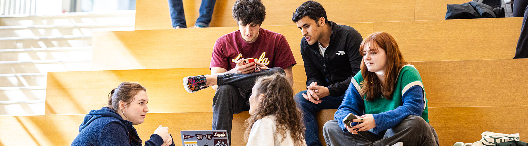 A group of Loyola students converse inside of the Schreiber Center A group of Loyola students converse inside of the Schreiber Center