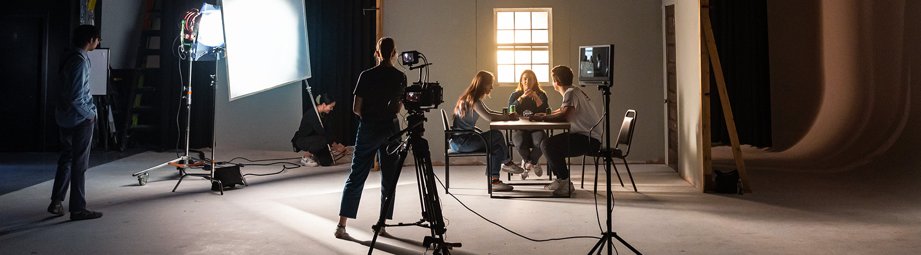 Loyolans on set as they shoot an indoor scene Loyolans on set as they shoot an indoor scene