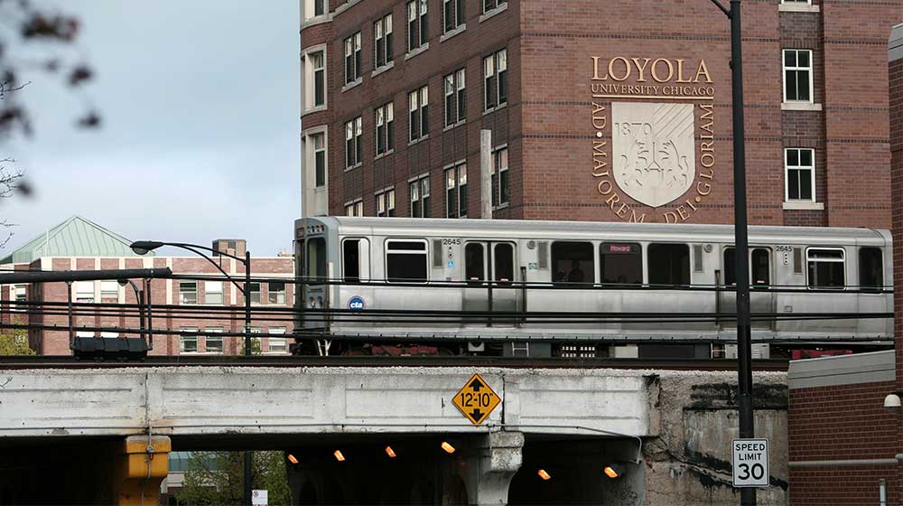 Chicago L train passes by Loyola University Chicago campus on overhead tracks Chicago L train passes by Loyola University Chicago campus on overhead tracks