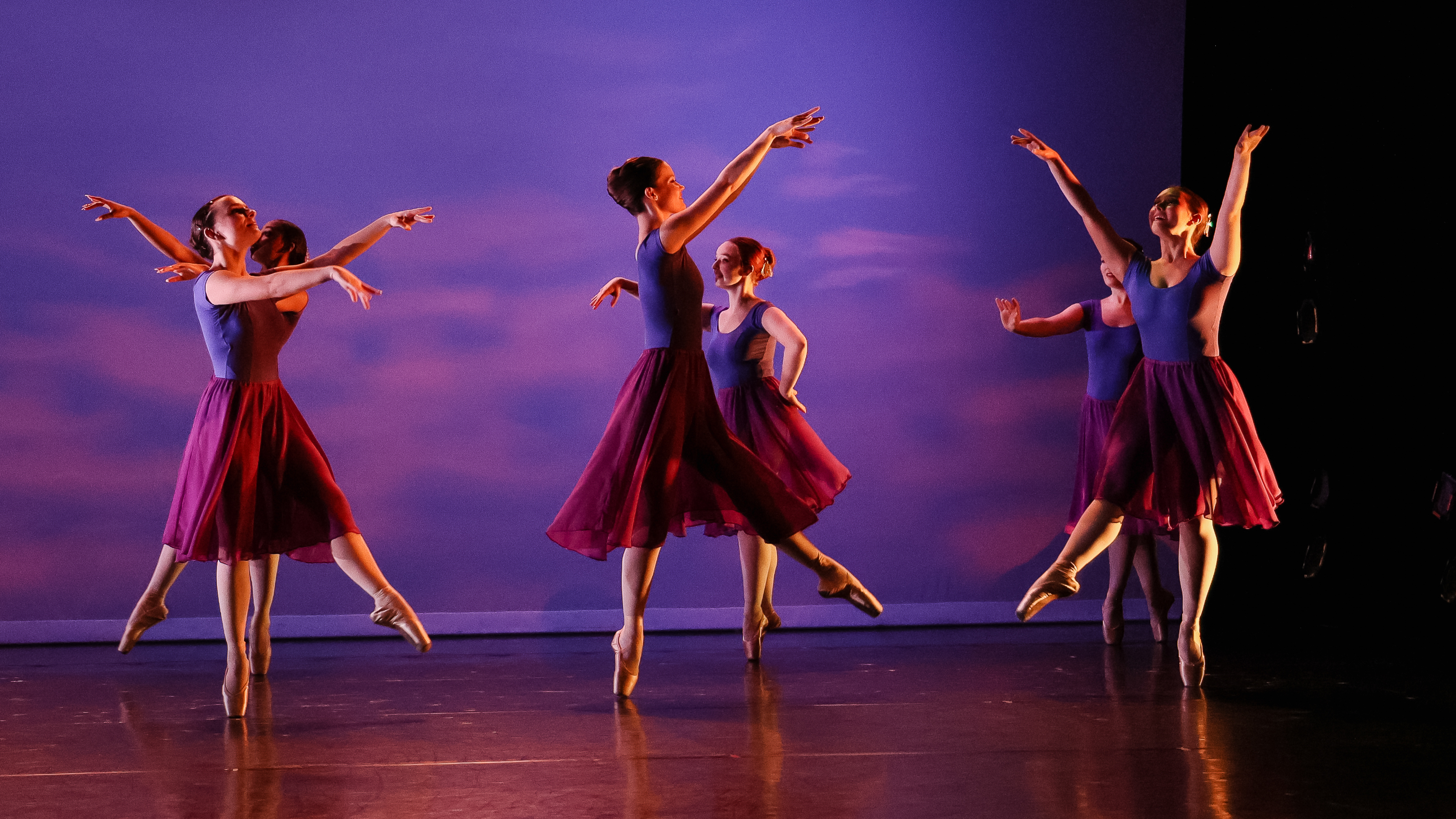Loyola Dance Students performing in front of a projection of the sky on the Newhart Family Theatre stage Loyola Dance Students performing in front of a projection of the sky on the Newhart Family Theatre stage