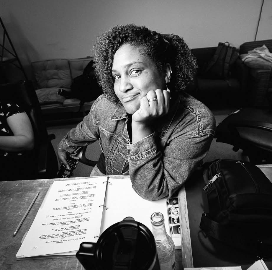 Tanji Harper sits at her desk resting her head on her shoulder. Tanji Harper sits at her desk resting her head on her shoulder.