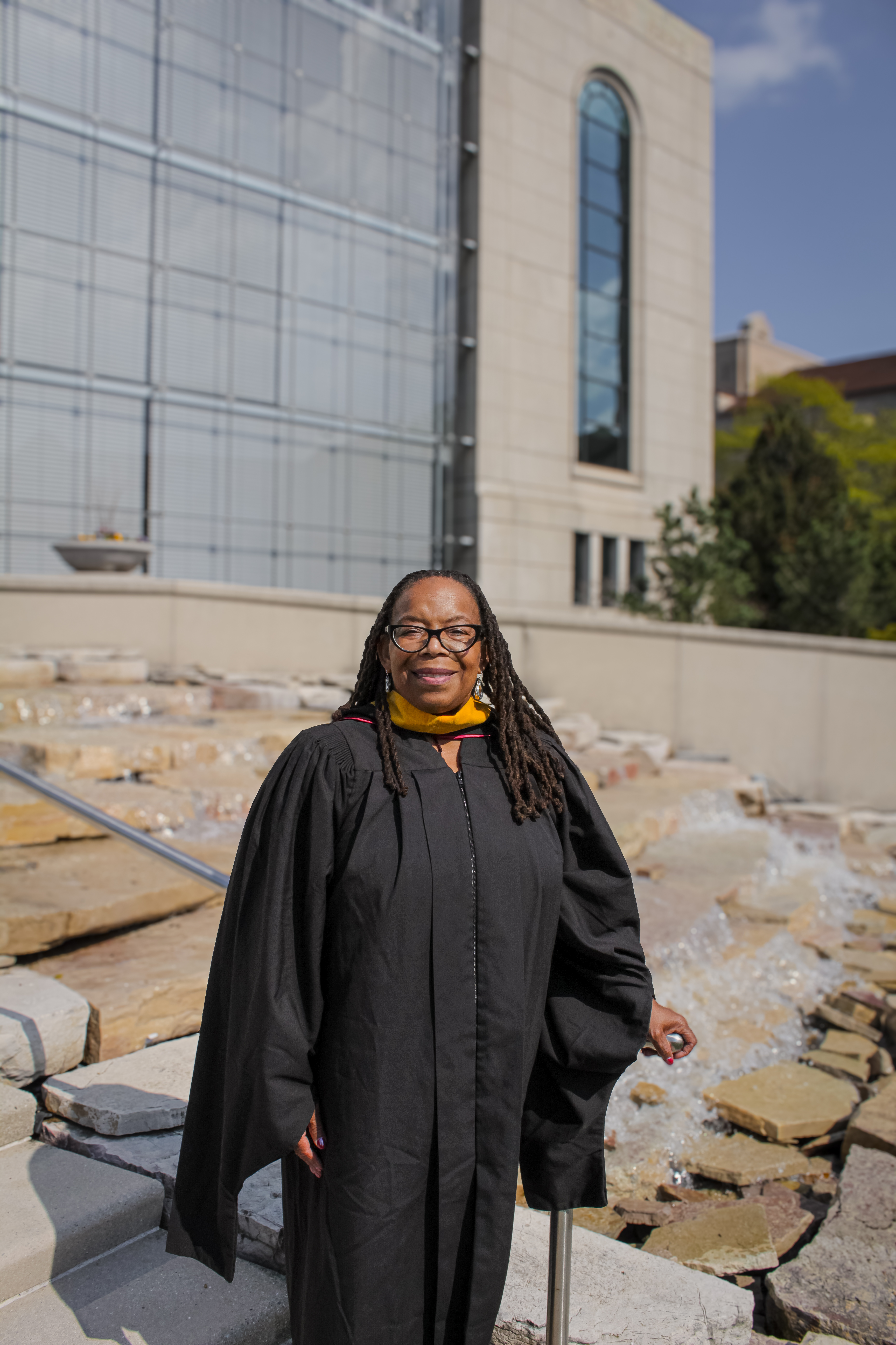 Professor Lisa Gilbert in front of Information Commons in graduation regalia Professor Lisa Gilbert in front of Information Commons in graduation regalia