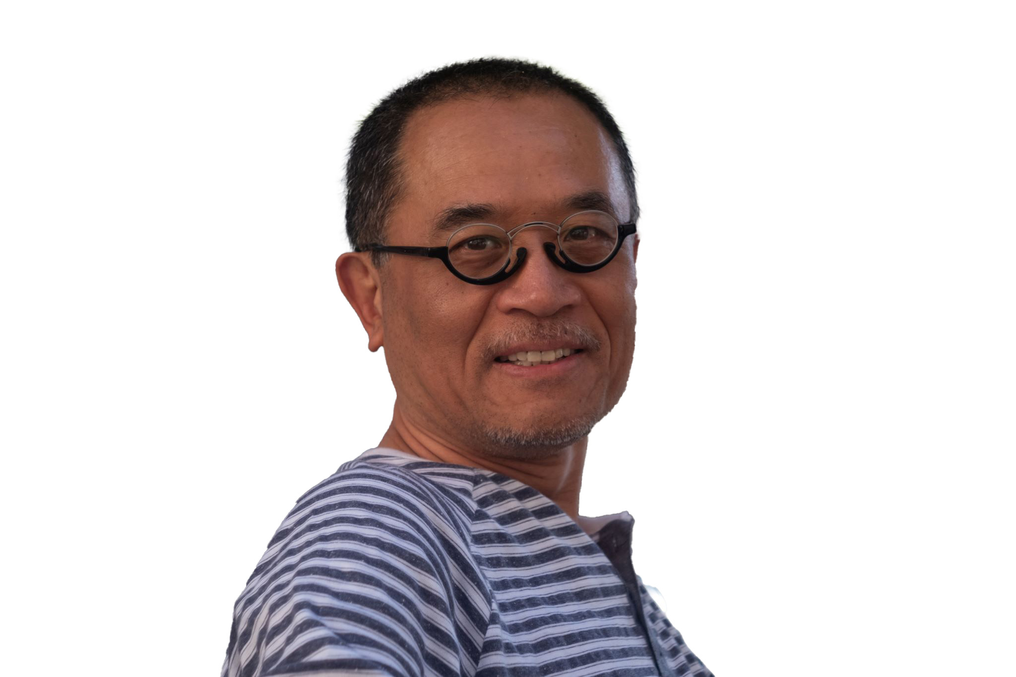 Headshot of a man wearing round glasses and a striped shirt, smiling against a light background Headshot of a man wearing round glasses and a striped shirt, smiling against a light background