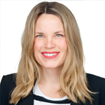 Rachael Persin, Internship Coordinator, with shoulder-length blonde hair and a bright smile, wearing a black blazer over a black-and-white striped top against a light background. Rachael Persin, Internship Coordinator, with shoulder-length blonde hair and a bright smile, wearing a black blazer over a black-and-white striped top against a light background.