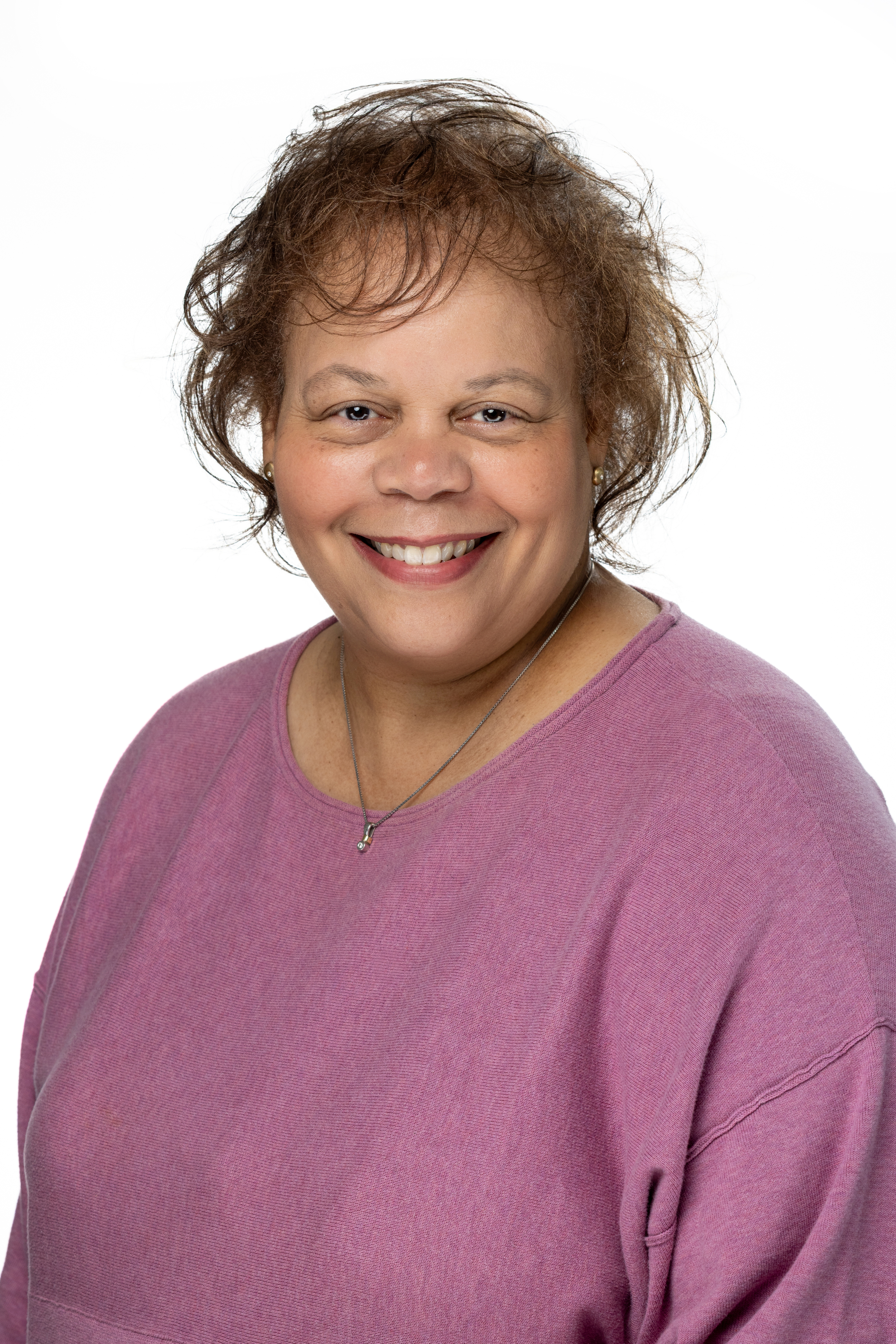Portrait of Stephanie L. Chapman, Assistant Dean for Administration in the School of Social Work, smiling and wearing a mauve top against a light background. Portrait of Stephanie L. Chapman, Assistant Dean for Administration in the School of Social Work, smiling and wearing a mauve top against a light background.