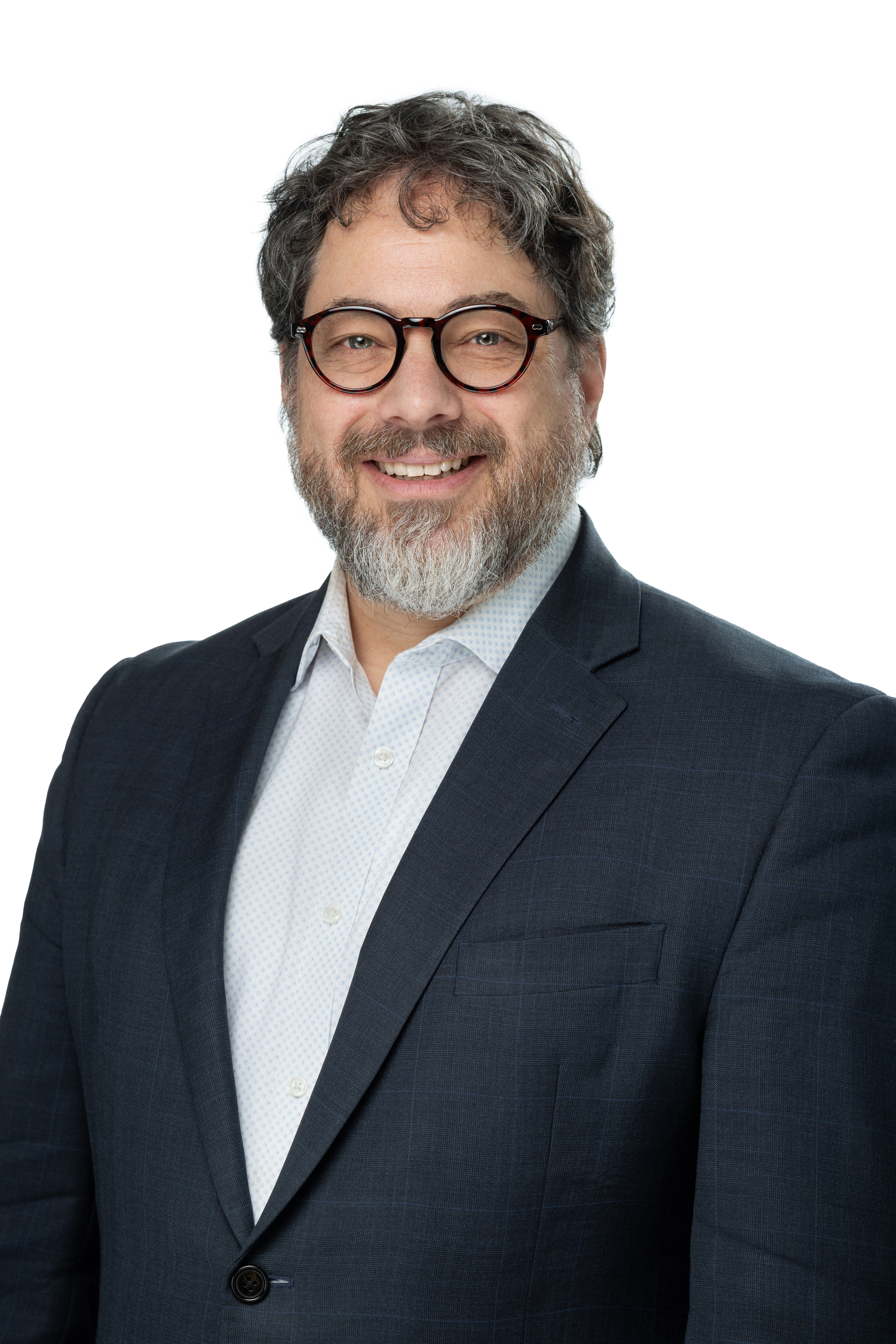 Jonathan B. Singer, Ph.D., LCSW, smiling and wearing round glasses, a dark blazer, and a light patterned shirt, with a salt-and-pepper beard and hair, against a light gray background. Jonathan B. Singer, Ph.D., LCSW, smiling and wearing round glasses, a dark blazer, and a light patterned shirt, with a salt-and-pepper beard and hair, against a light gray background.