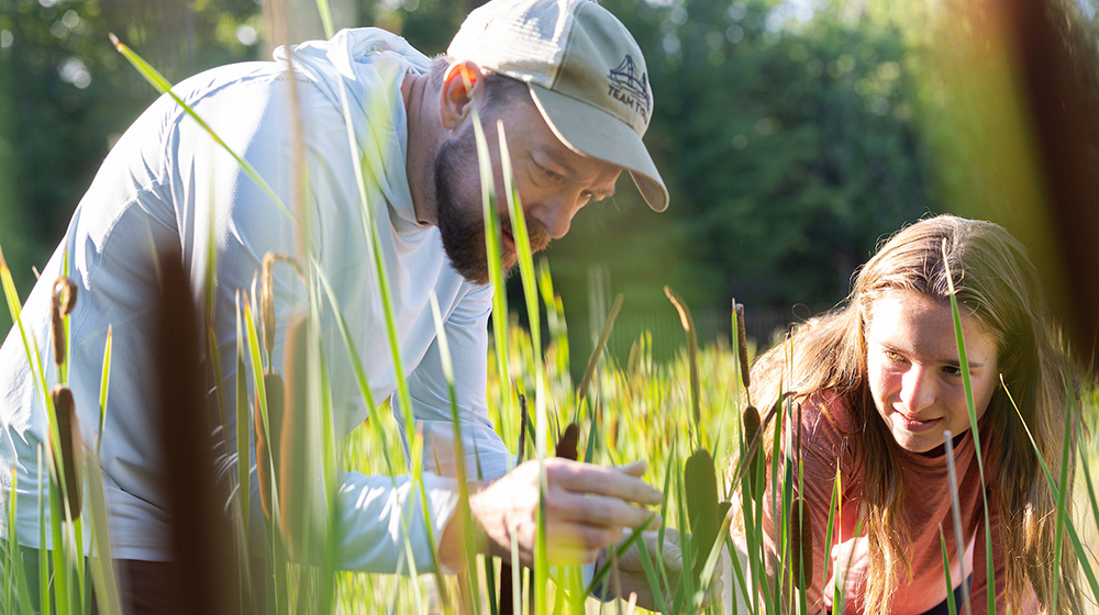 Brian Ohsowski and a student working in a wetland