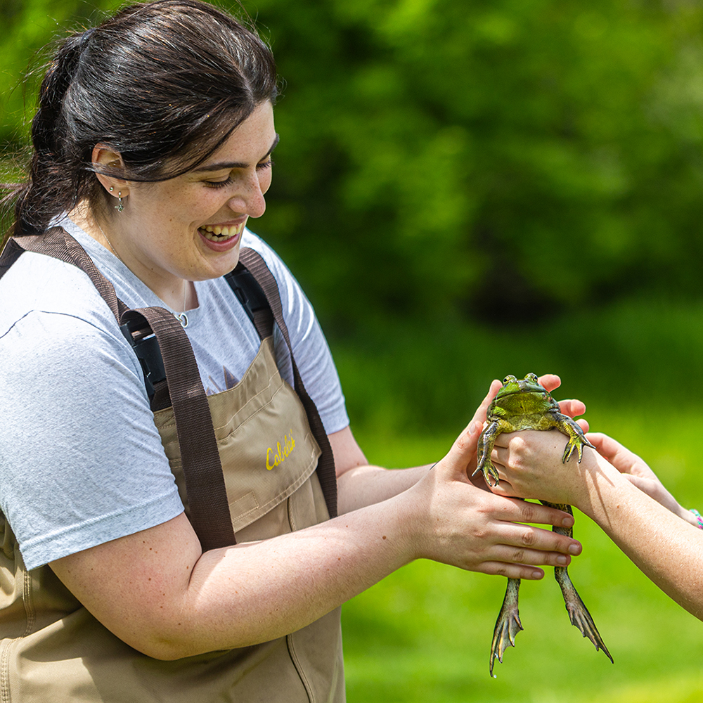 student holding a bullfrog student holding a bullfrog