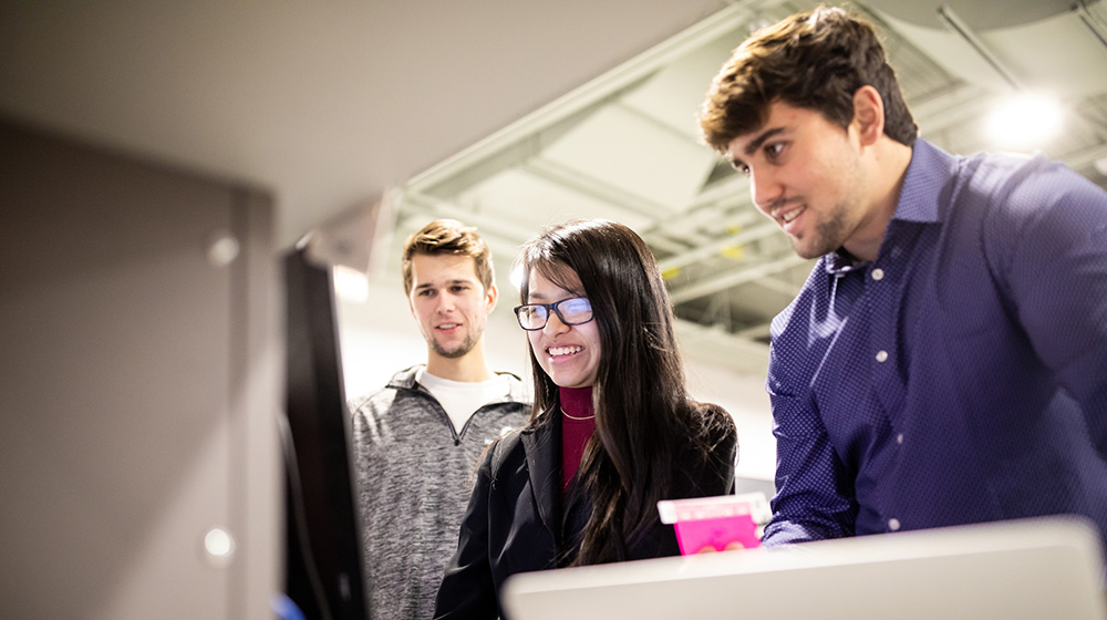 Three students work together in the Engineering Flex Lab.