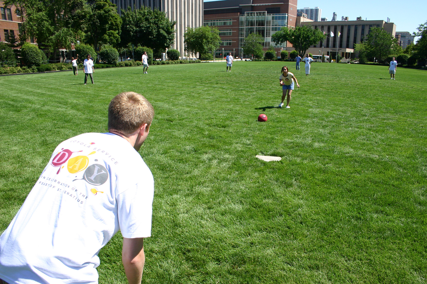 Staff playing kickball on Loyola's Lake Shore Campus.