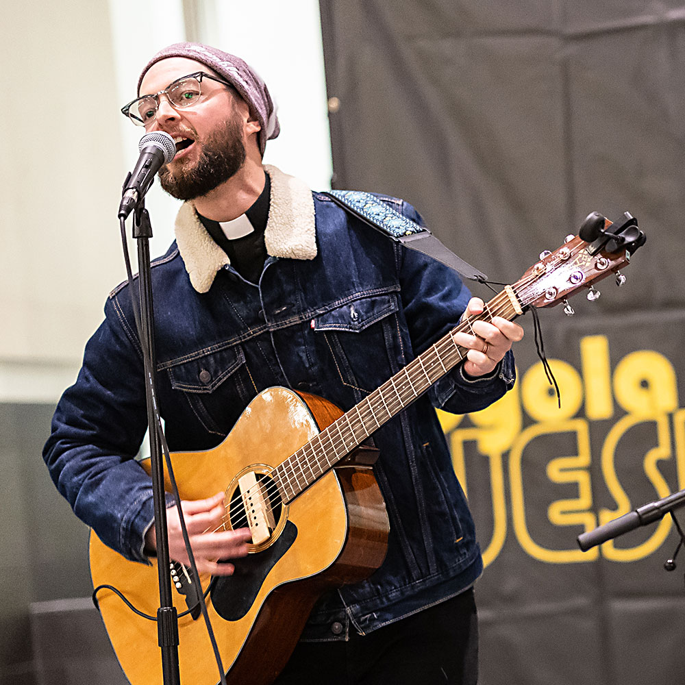 A First Year Studies Jesuit plays guitar at the Jesuit Jam.
