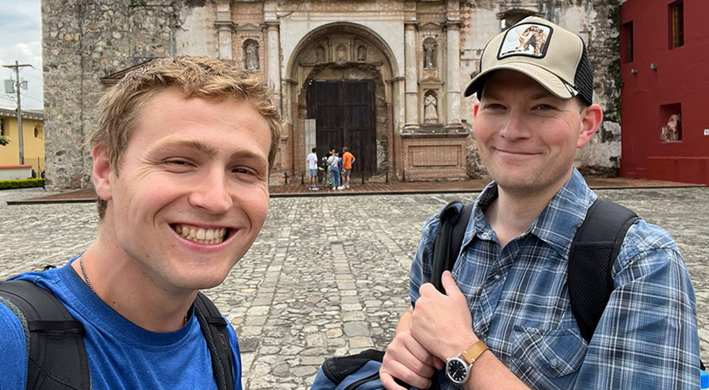 Two members Loyola's Jesuit First Studies group serve during a Summer Experience
