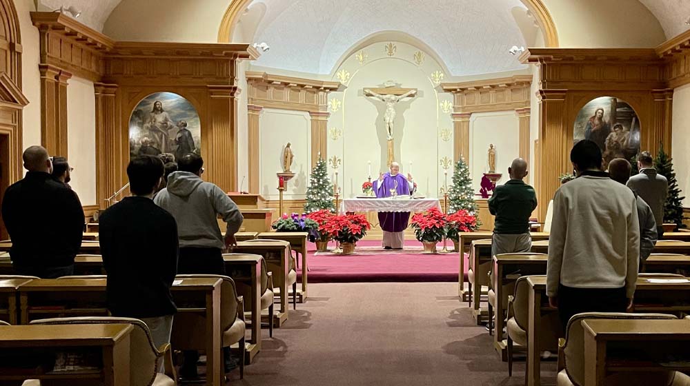 First Studies men participate in Mass during annual vow renewal triduum.