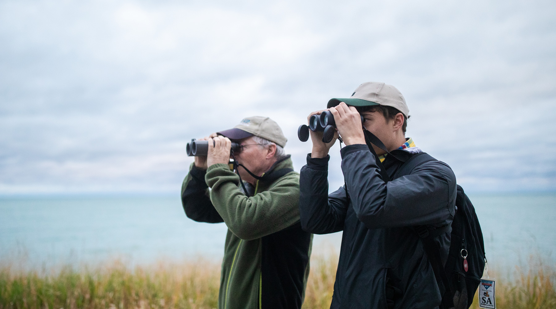 President's Medallion winner Kevin White spends early mornings bird-watching around Lake Shore Campus with his professor, Father Mitten, who records bird deaths from hitting glass buildings around campus. (Photo: Lukas Keapproth)