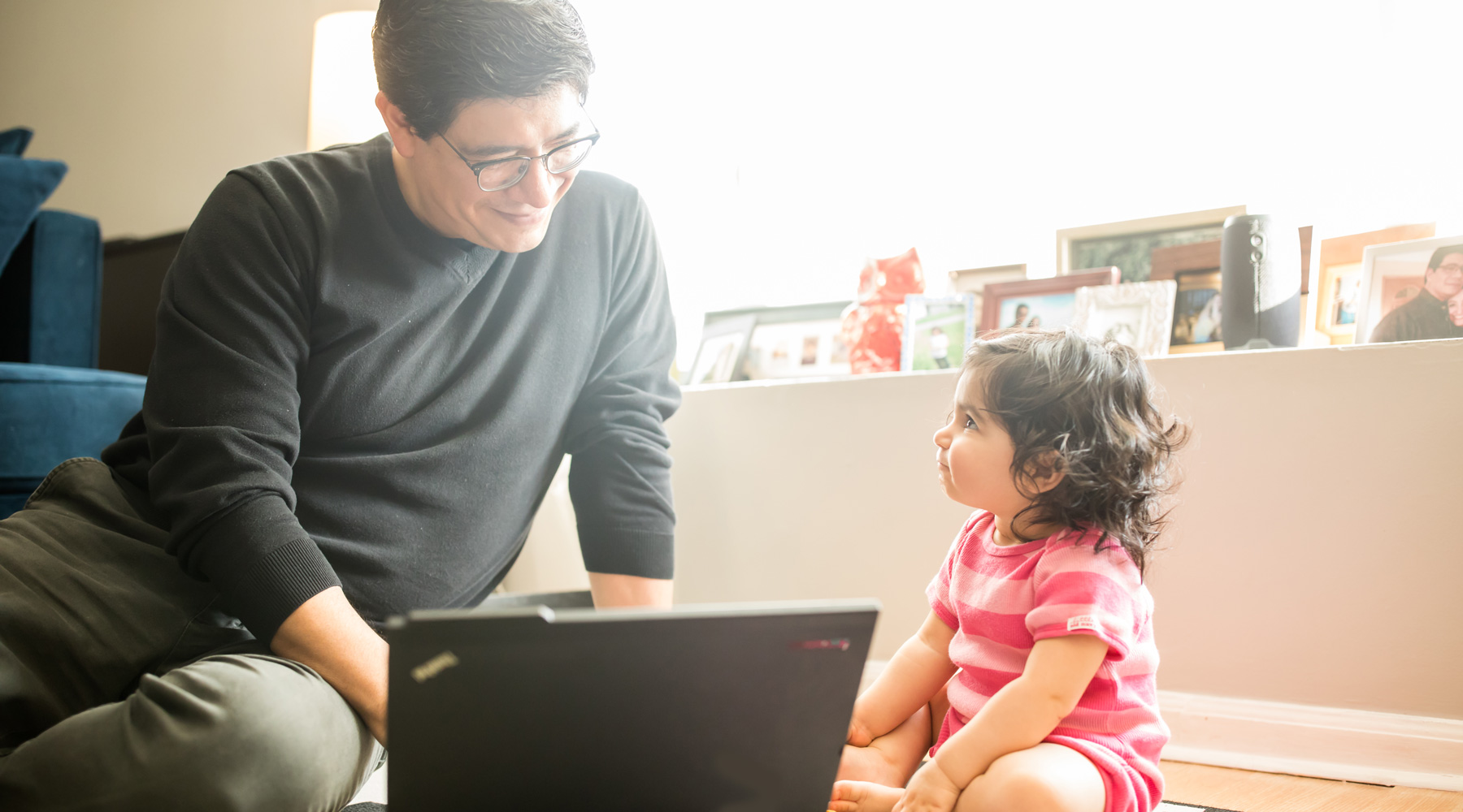 President's Medallion winner Adrian De La Cruz studies at home in Hoffman Estates with his one-year-old child, Mia. (Photo: Lukas Keapproth)
