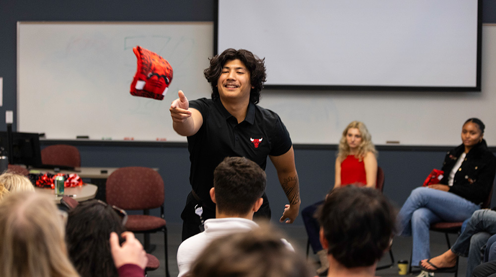 Alum Aidan Alandy tosses a bulls tee-shirt to a student Alum Aidan Alandy tosses a bulls tee-shirt to a student