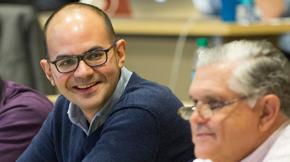 Julian Diaz smiling and looking to his left at a conference in Chicago