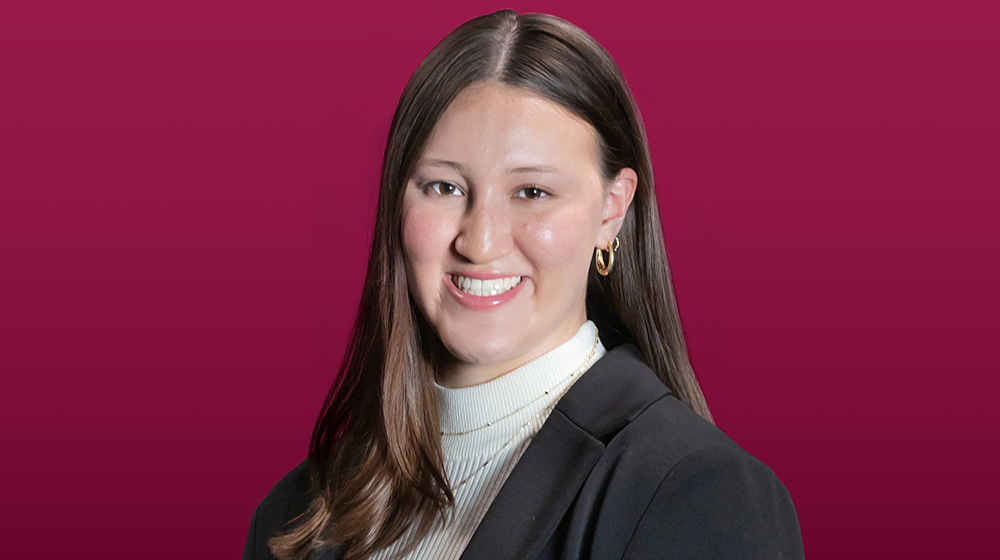 Headshot of Jillian Cole on a maroon background Headshot of Jillian Cole on a maroon background