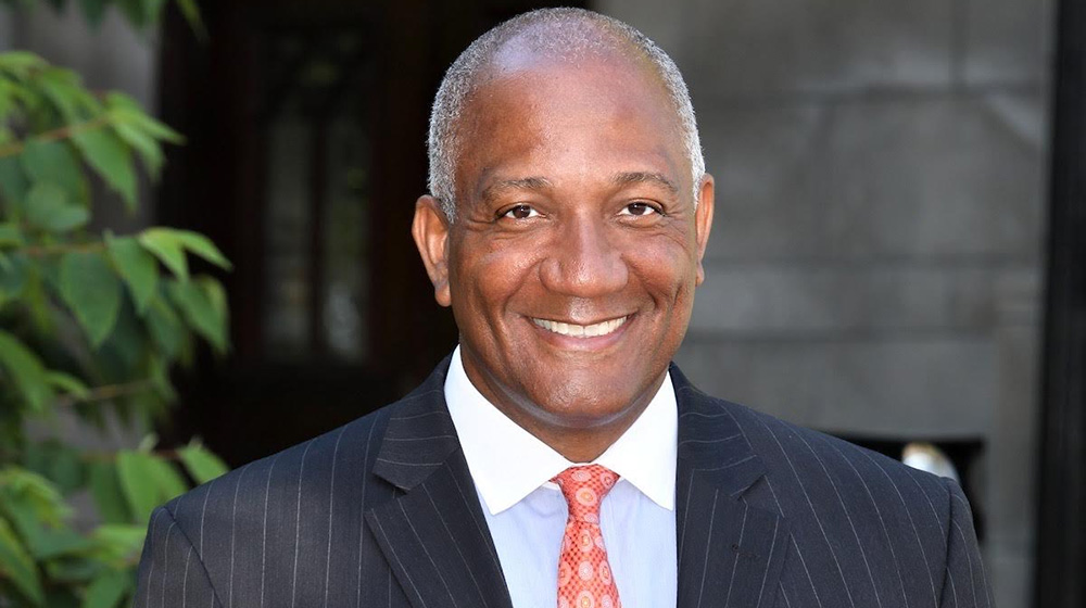 headshot of marquis miller in a suit and tie headshot of marquis miller in a suit and tie