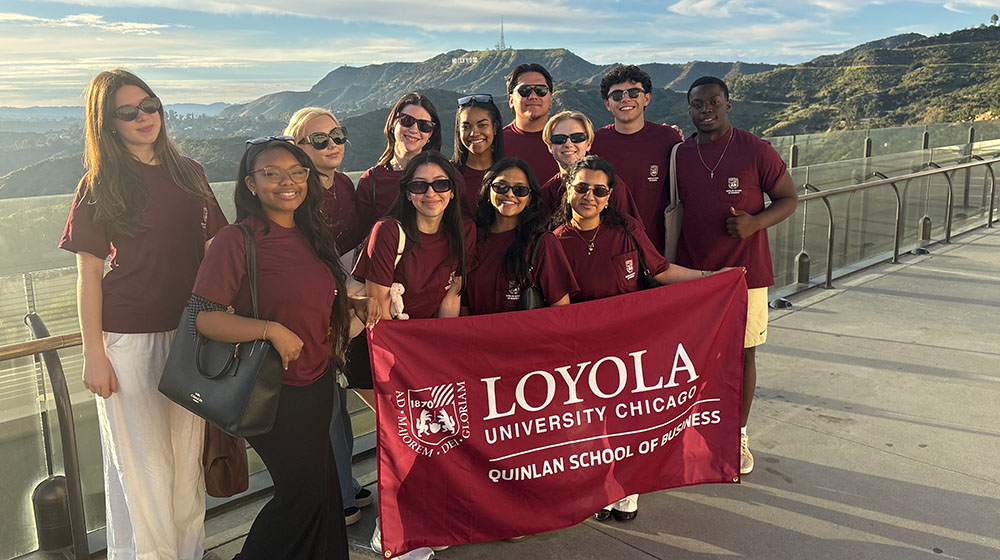 Quinlan students hold a Quinlan flag overlooking the Hollywood sign Quinlan students hold a Quinlan flag overlooking the Hollywood sign