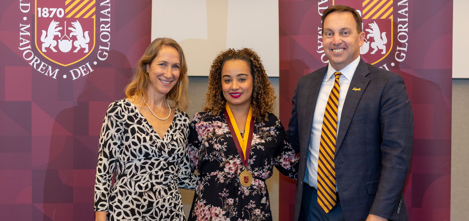 Loyola SCPS President's Medallion winner with dean and president