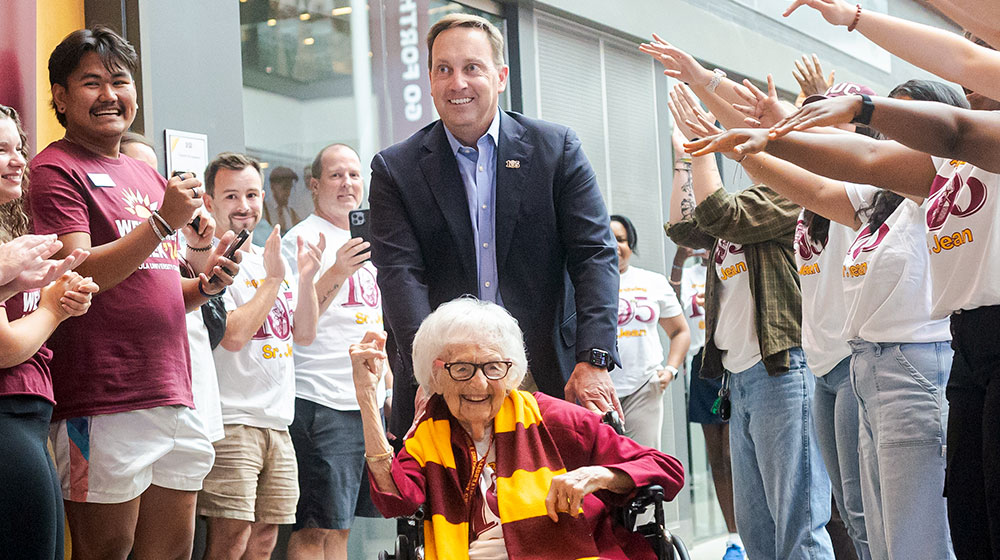 President Reed and students gather to celebrate Sister Jean's 105th birthday