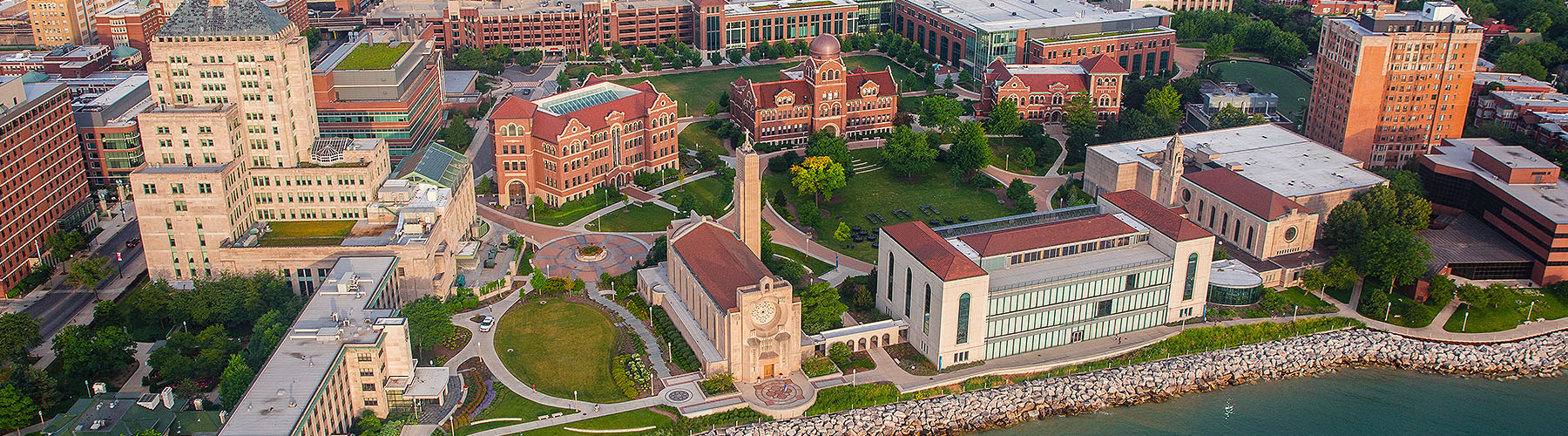 An aerial view of Loyola University Chicago's Lake Shore campus during the golden hour
