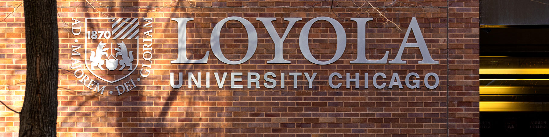 The Loyola University Chicago Logo sunlit on the Water Tower campus
